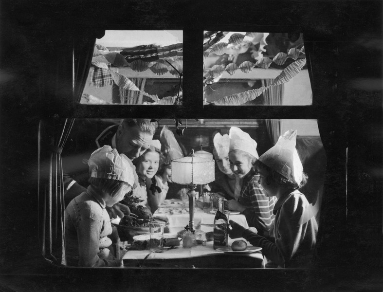 1938. Дети наслаждаются праздничной вечеринкой в ​​вагоне-ресторане LMS, когда едут домой на Рождество. 23 декабря